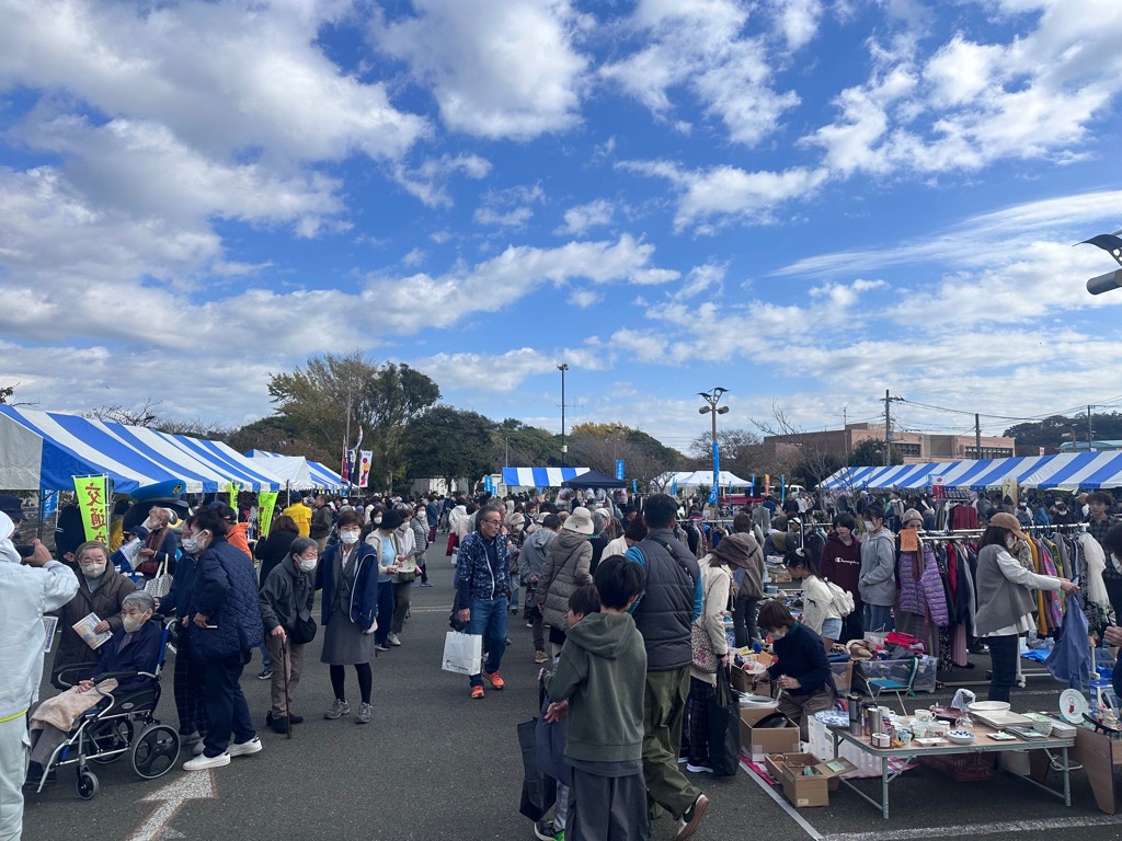 屋外のフリーマーケットや出展を見ている来場者